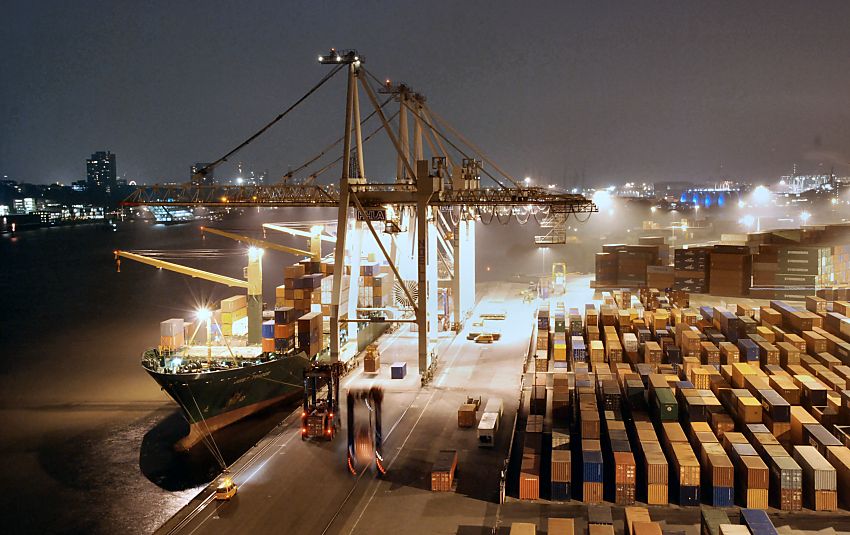 011_15288 ein Containerschiff liegt am Kai des Container Terminals Burchard, auf der anderen Seite der Elbe die beleuchteten Huser von Hamburg Neumhlen. Containercarrier transportieren die Container auf die Lagerflche, auf der die Metallboxen in dichten Reihen  gestapelt sind. Der Hamburger Hafen liegt mit z. Zt. 8.1 Mio TEU weltweit auf Platz acht der Containerhfen. TEU = Container, die 20 Fu Lnge (6,096 m) + die Breite von 8 Fu ( 2,44 m) haben; (Twenty-foot Equivalent Unit) www.fotograf-hamburg.de