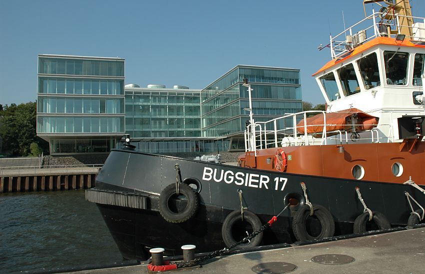 011_26030  Bilder vom Hamburger Hafen - Foto vom Hafenschlepper :: Der  Hamburger Schlepper BUGSIER 17 liegt am Ponton vor Hamburg Neumhlen - an seinem Bug befindet sich eine dicke Gummileiste, mit dem das starke Arbeitsschiff die Frachter in ihre Position schieben kann. An den Seiten des Schleppers hngen Gummireifen als Fender mit denen das Schiff und auch andere vor einem harten Stoss geschtzt werden. Im Hintergrund die moderne Architektur der Hamburger Brogebude an der Hafenpromenade von Neumhlen.  www.christoph-bellin.de