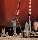 011_26099 Ein Schweisser arbeitet im Trockendock der Werft an einem Schiffsrumpf. ber ihm sind die Markierungen fr den Tiefgang des Schiffes zu erkennen. Auf dem Boden steht der Anker des Schiffes. www.hamburg-fotograf.com